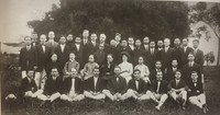 Group photograph of people standing and sitting in rows